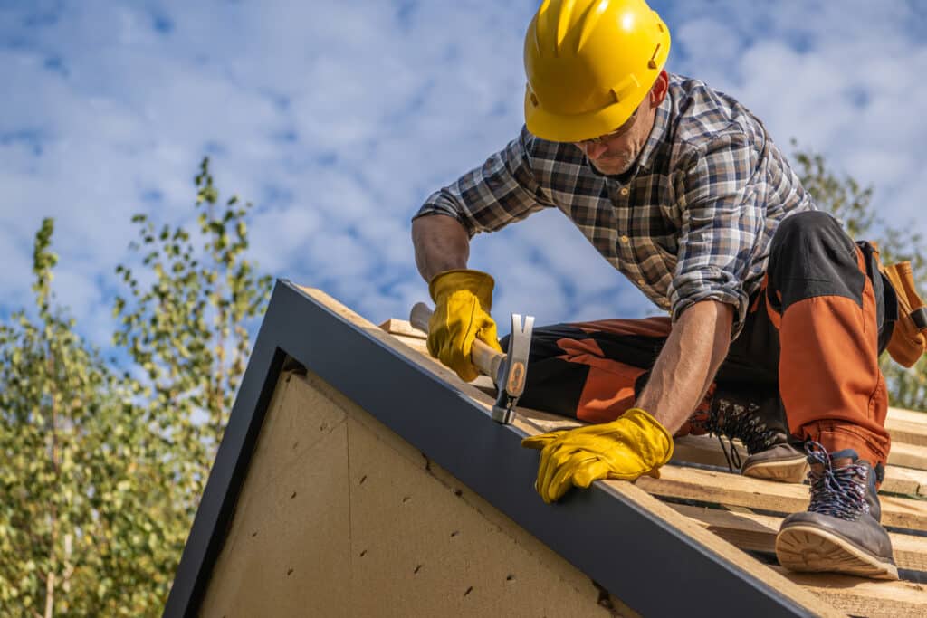Caucasian Professional Roof Contractor and His Job. Roofing Theme.
