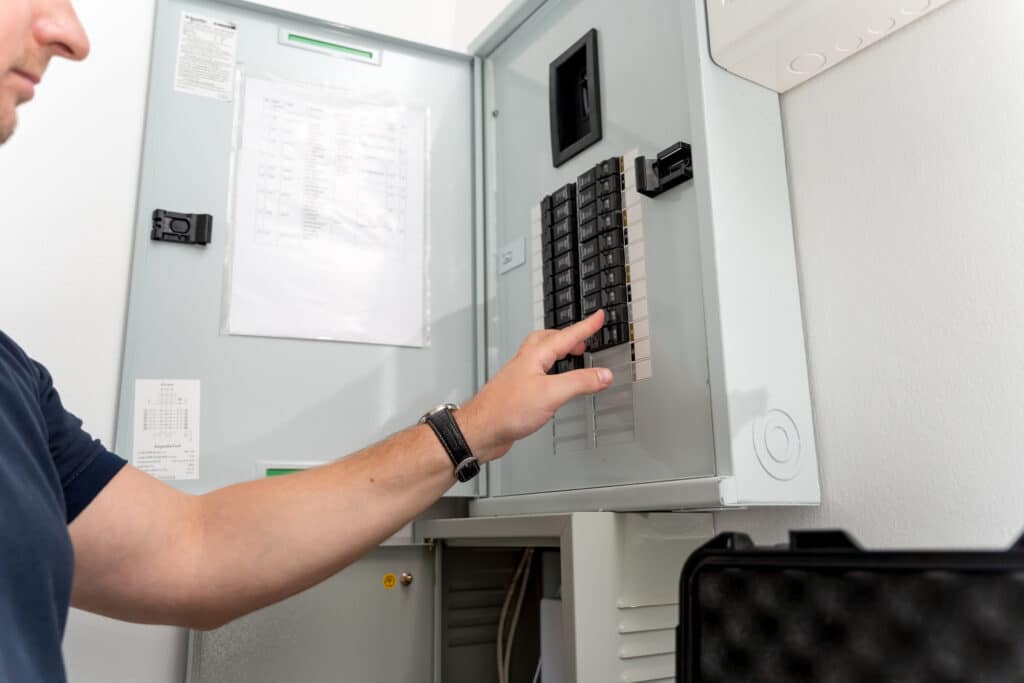 A technician works with a demo kit of the smart home system.