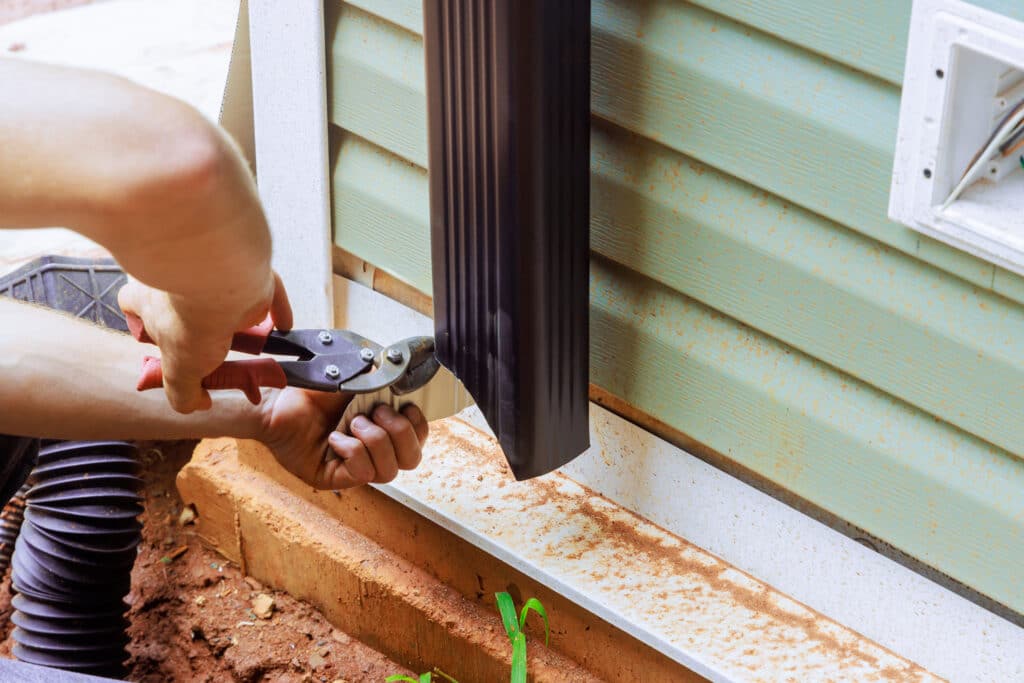 Handyman it is assembling with installation of gutter channel are attached to roof