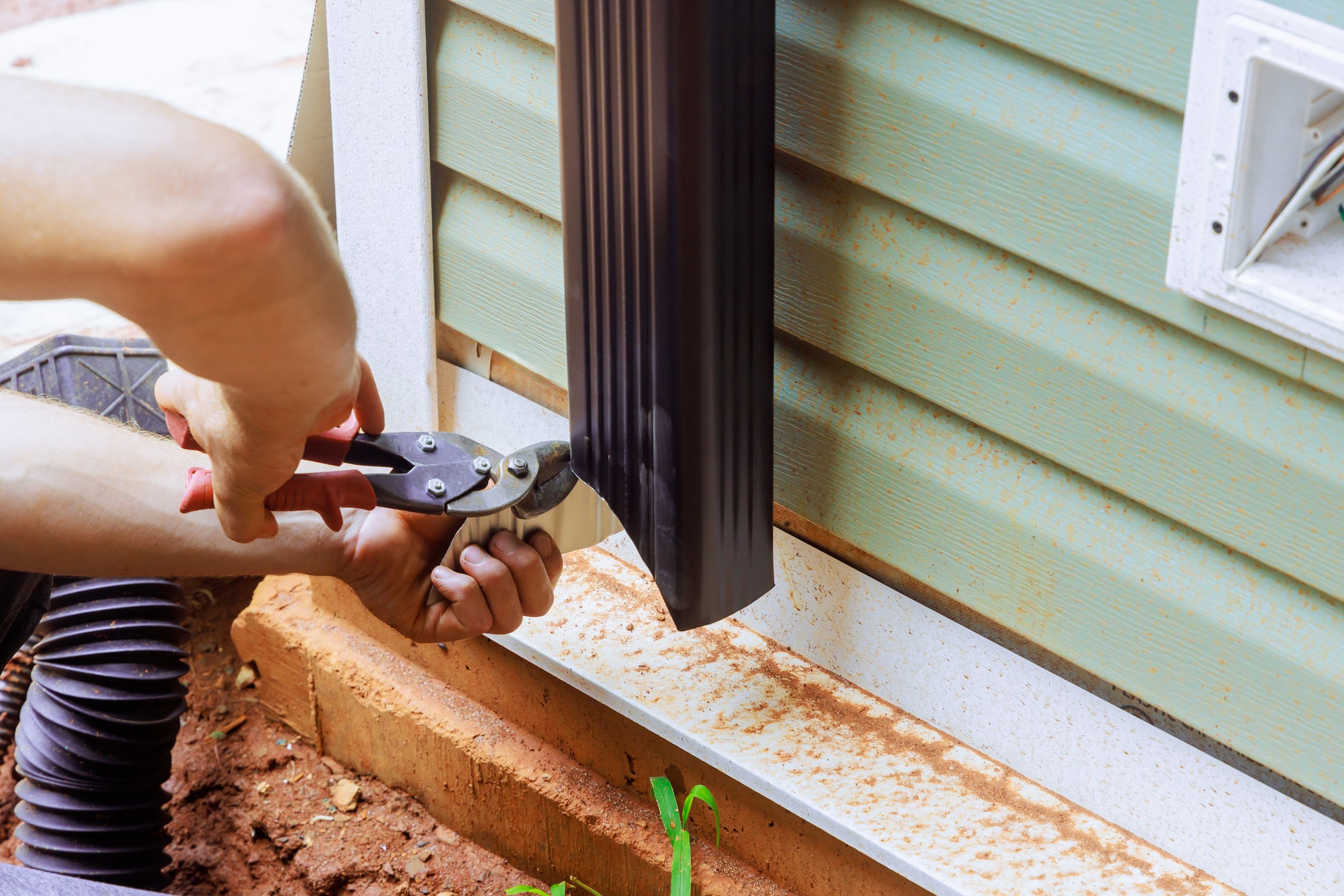Handyman it is assembling with installation of gutter channel are attached to roof