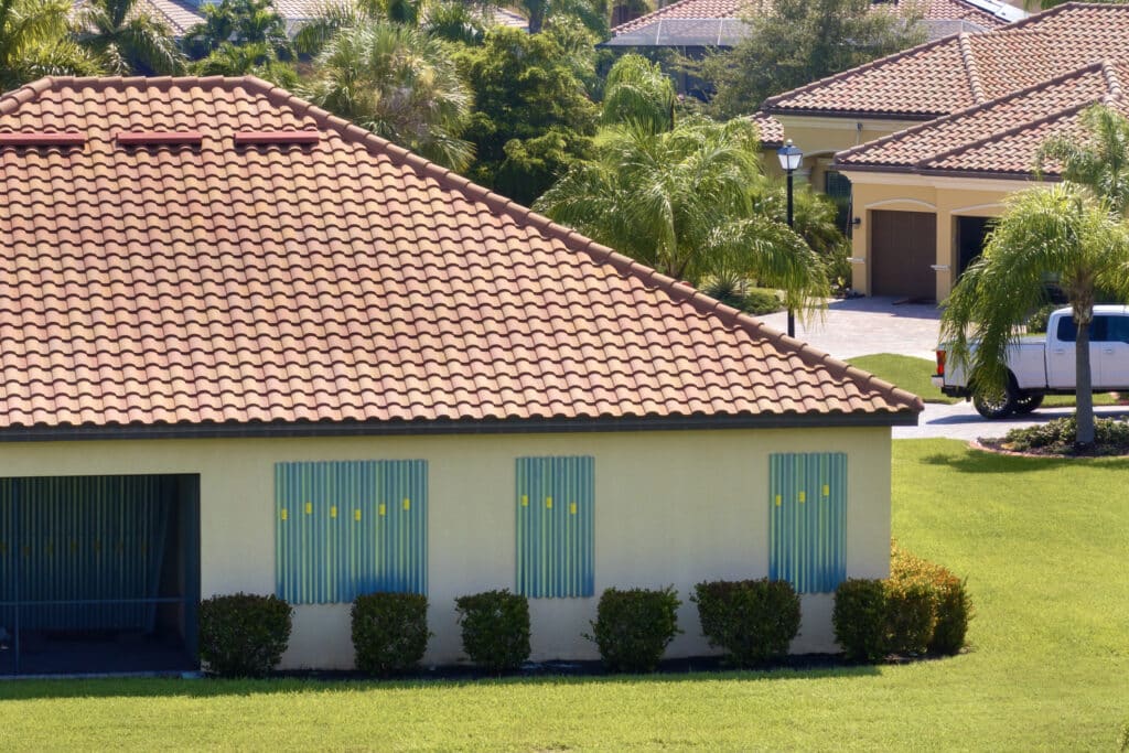 Boarded windows with storm shutters for hurricane protection of Florida home. Protective measures before natural disaster.